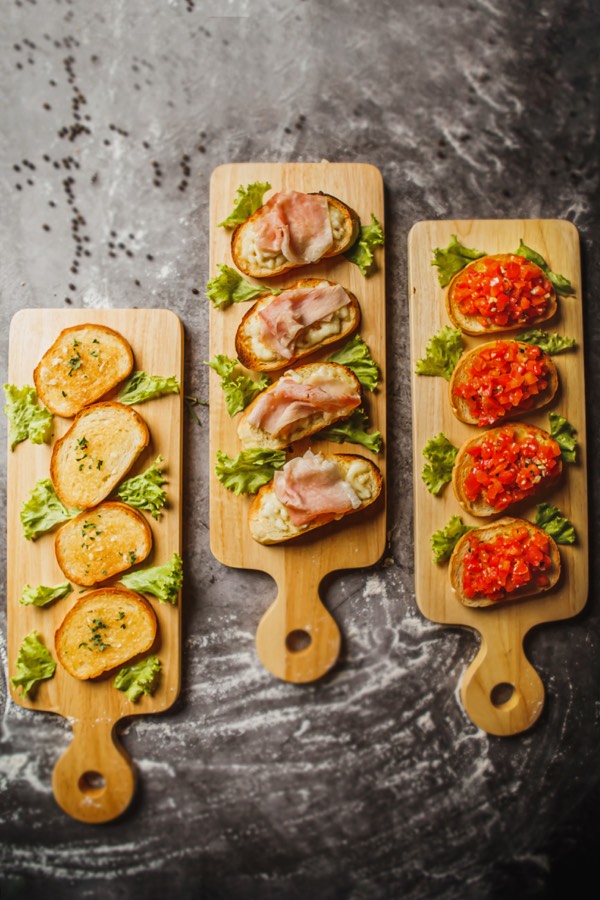 Trio of bruschette boards — garlic, mozzarella and ham, fresh tomato