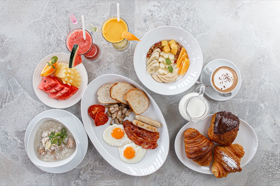 VIVA breakfast spread — eggs and bacon, croissants, granola bowl, fresh fruit, cappuccino and juices