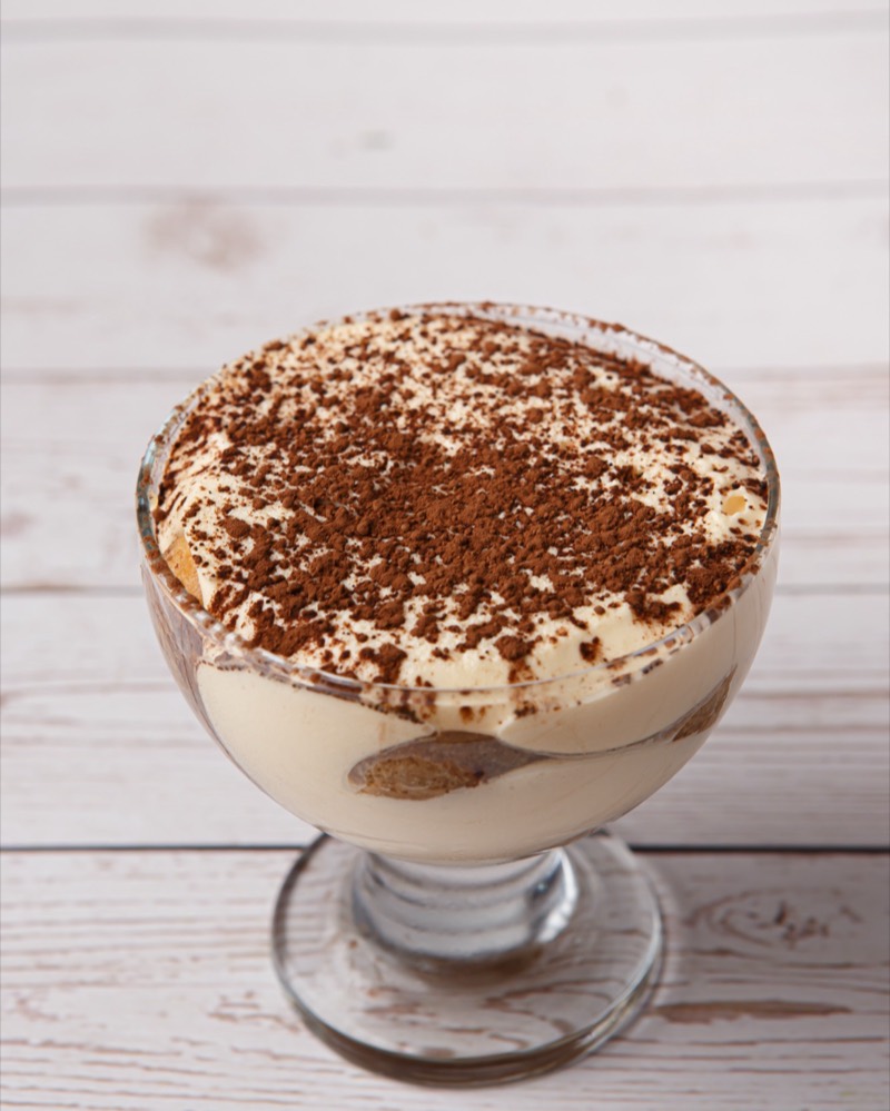 Tiramisù dusted with cocoa, served in a glass coupe